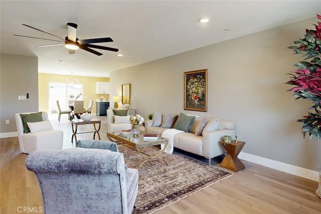 living room with recessed lighting, baseboards, a ceiling fan, and light wood finished floors
