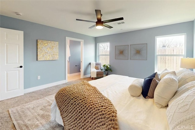 carpeted bedroom featuring baseboards, visible vents, and ceiling fan