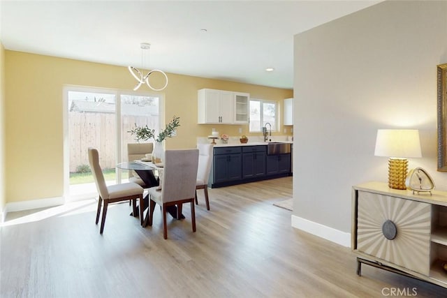 dining room featuring baseboards and light wood-style floors