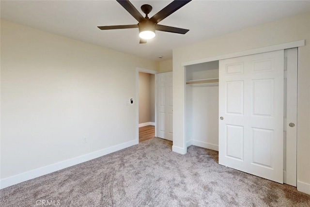 unfurnished bedroom with a closet, a ceiling fan, baseboards, and carpet floors