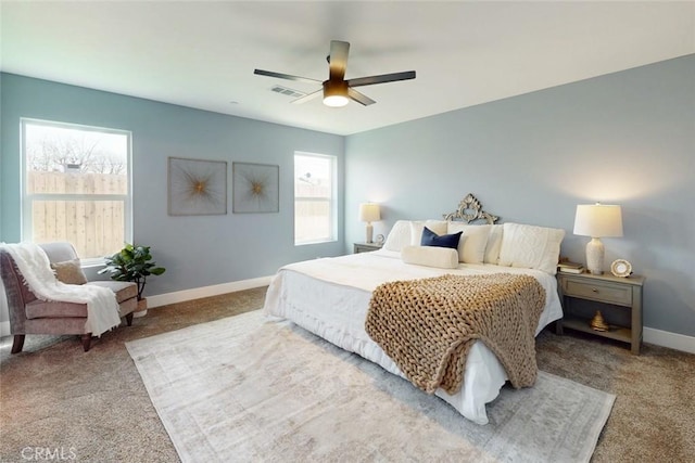 carpeted bedroom featuring visible vents, ceiling fan, and baseboards