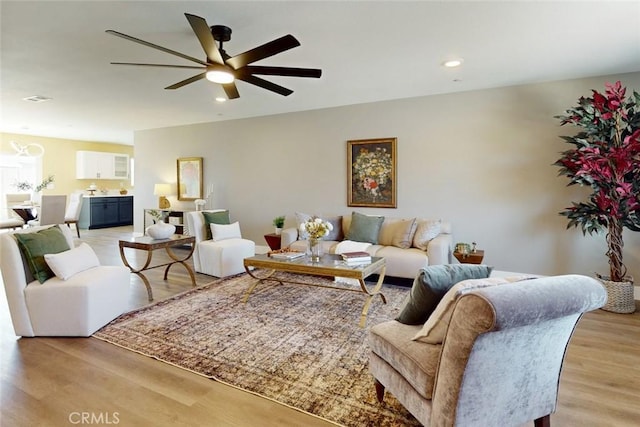 living area featuring light wood-style flooring, recessed lighting, visible vents, and ceiling fan