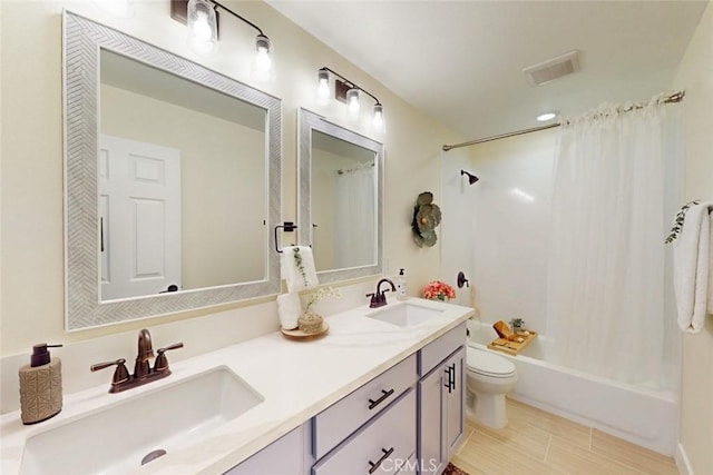 full bathroom featuring a sink, visible vents, shower / bathtub combination with curtain, and toilet