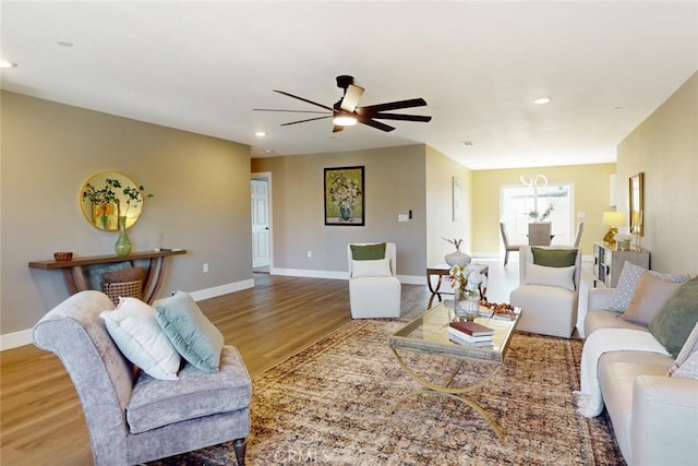 living room with recessed lighting, wood finished floors, and baseboards