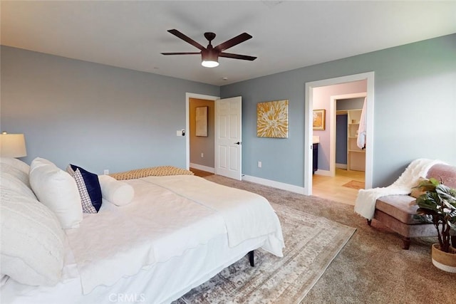bedroom featuring baseboards, light carpet, and a ceiling fan