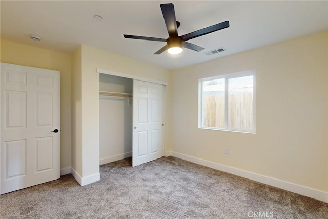 unfurnished bedroom with visible vents, baseboards, carpet, a closet, and a ceiling fan