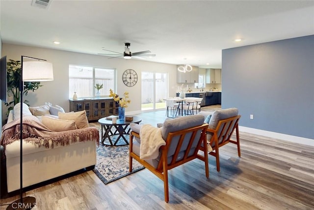 living room featuring recessed lighting, baseboards, light wood finished floors, and ceiling fan