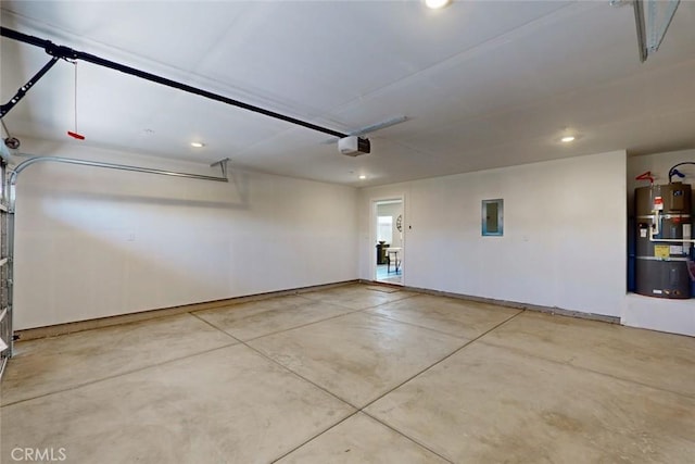 garage with strapped water heater, electric panel, a garage door opener, and recessed lighting