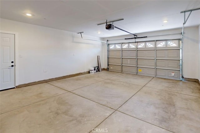 garage featuring a garage door opener and baseboards