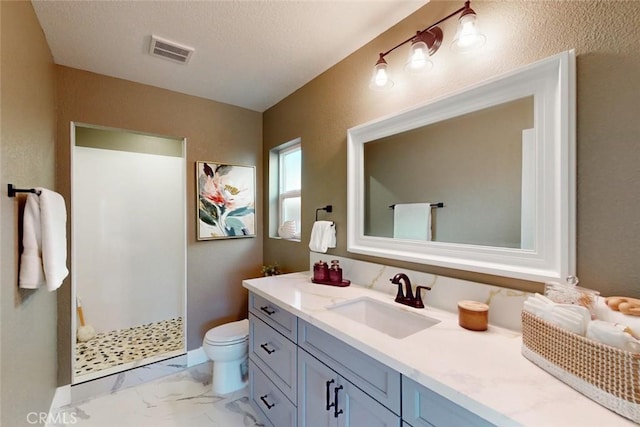 bathroom featuring vanity, visible vents, walk in shower, toilet, and marble finish floor