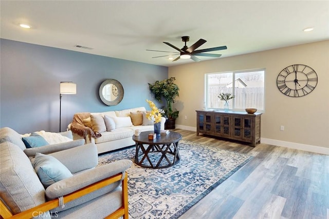 living area with visible vents, baseboards, recessed lighting, wood finished floors, and a ceiling fan