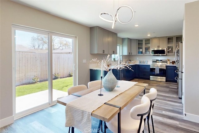 dining room featuring recessed lighting, baseboards, and light wood-style floors