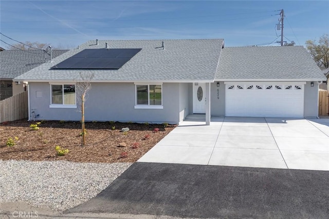 single story home featuring fence, driveway, an attached garage, stucco siding, and a shingled roof