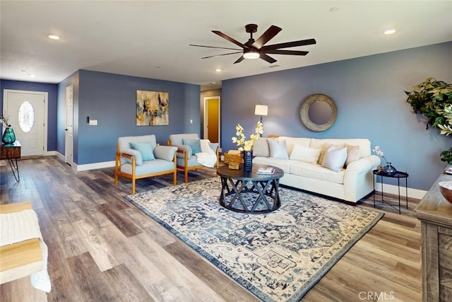 living area featuring recessed lighting, baseboards, light wood-style flooring, and a ceiling fan