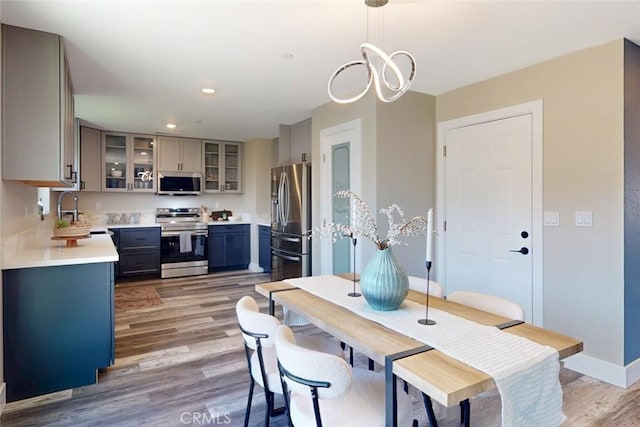 dining area with recessed lighting, baseboards, and light wood finished floors