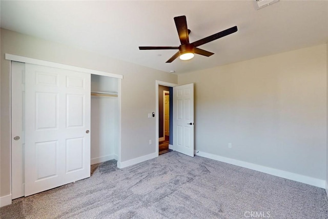 unfurnished bedroom featuring a ceiling fan, visible vents, baseboards, carpet floors, and a closet