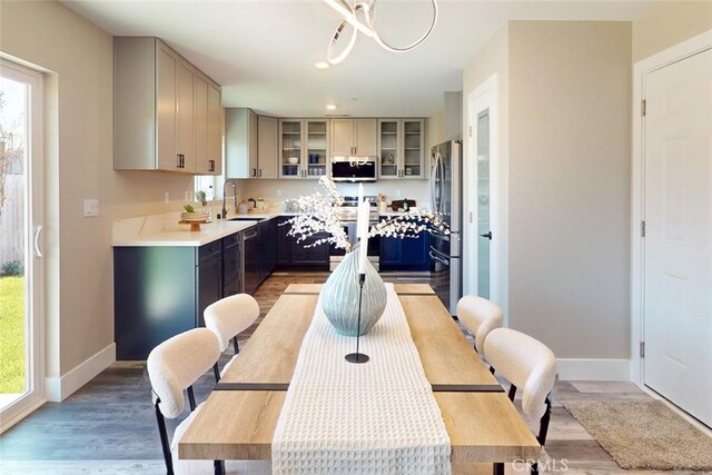 dining room with light wood finished floors and baseboards