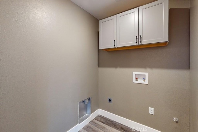 washroom featuring wood finished floors, baseboards, hookup for an electric dryer, cabinet space, and washer hookup