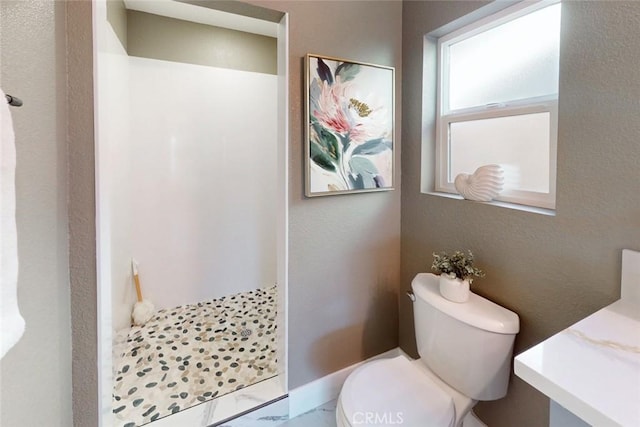 full bath with a shower stall, toilet, a textured wall, and marble finish floor