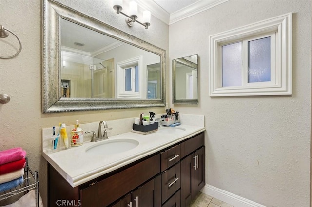 full bathroom featuring double vanity, ornamental molding, a textured wall, and a sink