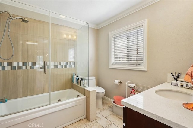 full bathroom featuring crown molding, baseboards, bath / shower combo with glass door, toilet, and vanity