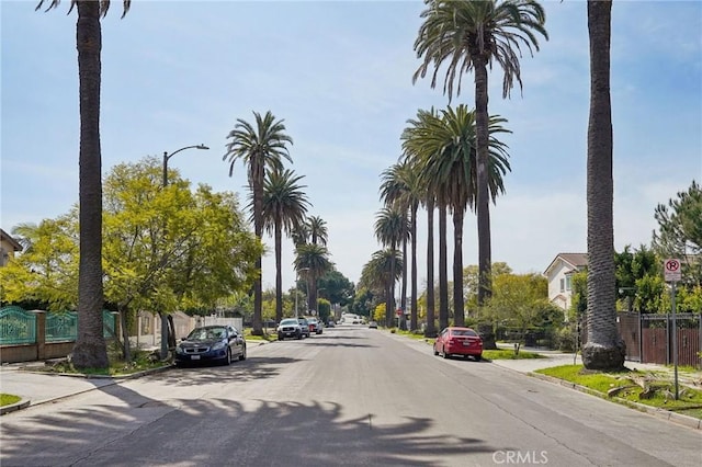 view of street with curbs, traffic signs, and sidewalks