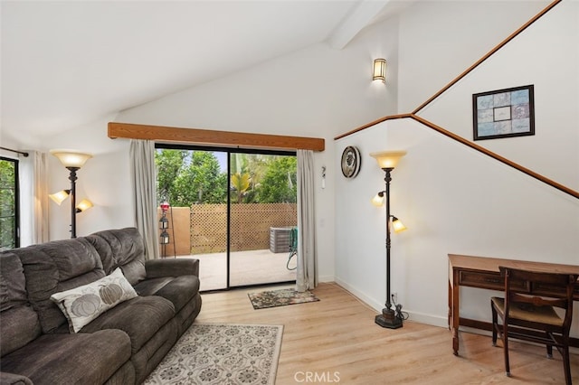 living area featuring beam ceiling, baseboards, light wood-type flooring, and high vaulted ceiling