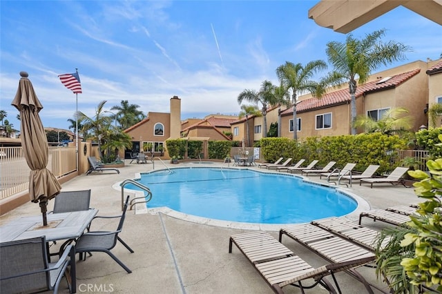 pool featuring a patio and fence