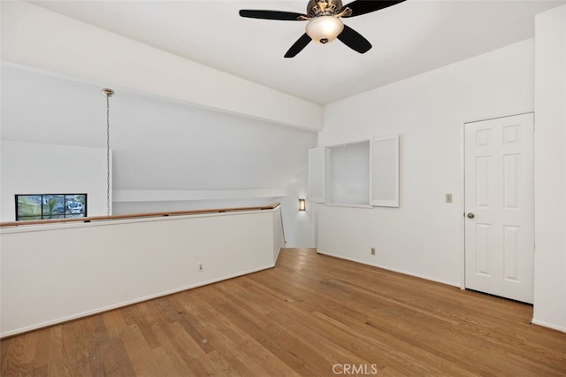 empty room with wood finished floors and ceiling fan