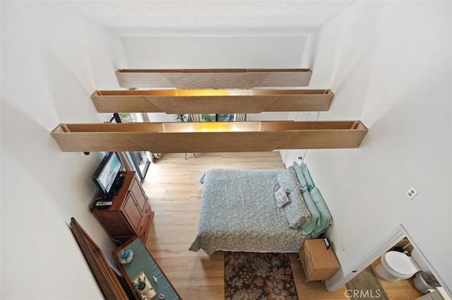 interior space featuring a textured ceiling and wood finished floors