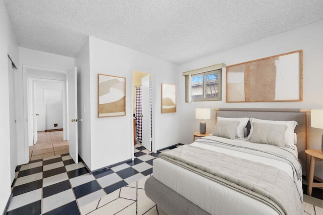 bedroom with tile patterned floors and a textured ceiling