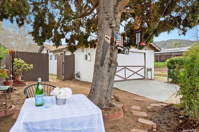 exterior space featuring a gate, fence, and a garage