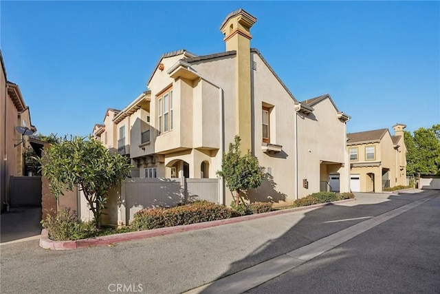 view of property featuring a residential view and fence