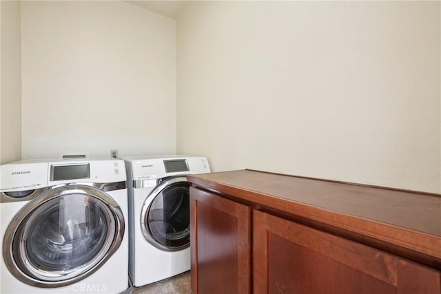 laundry room with cabinet space and washer and clothes dryer