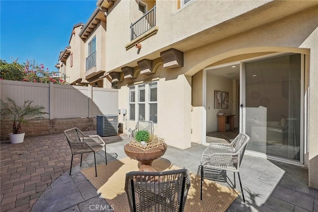 view of patio / terrace with central AC unit and fence