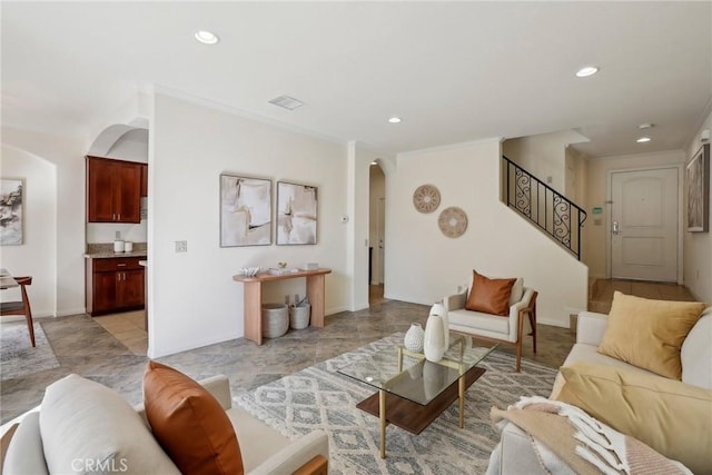 living room featuring arched walkways, visible vents, recessed lighting, and stairway