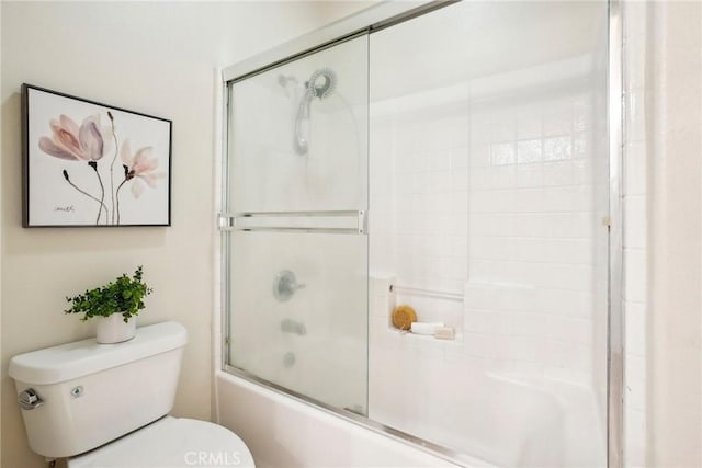 full bath featuring toilet and bath / shower combo with glass door