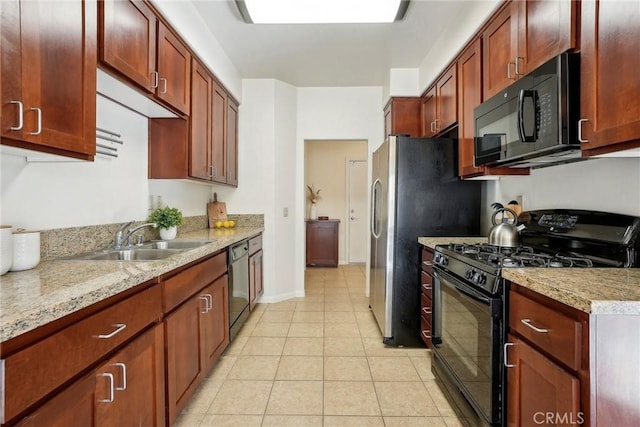 kitchen featuring black appliances, a sink, light stone counters, light tile patterned flooring, and baseboards