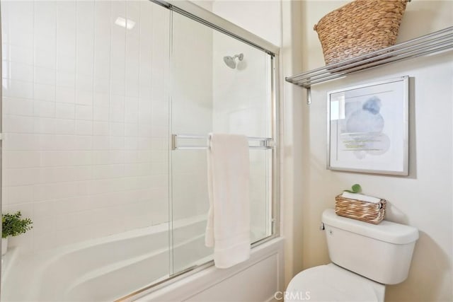 full bathroom featuring toilet and bath / shower combo with glass door