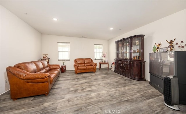 living area with recessed lighting, wood finished floors, and visible vents