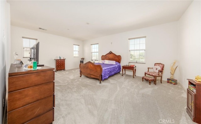 bedroom featuring light colored carpet and visible vents