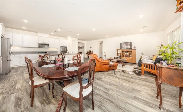 dining area with recessed lighting and light wood-style floors