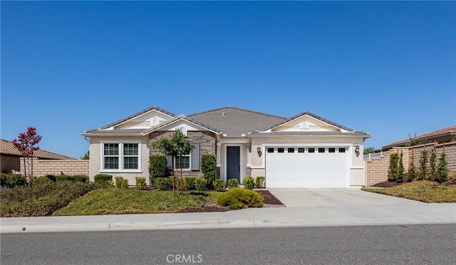 ranch-style home with fence, stucco siding, concrete driveway, a garage, and a tile roof