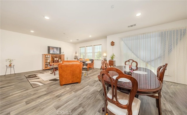 dining space with recessed lighting, visible vents, and wood finished floors