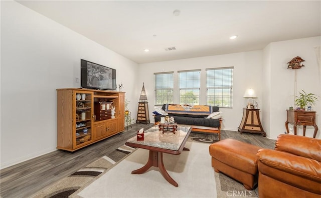 living area with visible vents, recessed lighting, baseboards, and wood finished floors