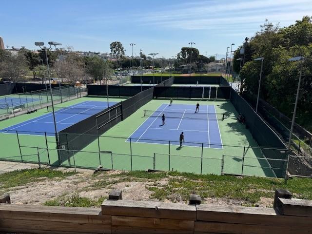 view of sport court featuring fence