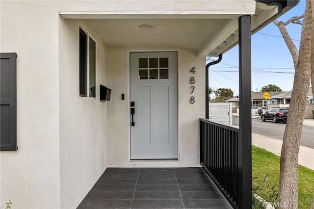 property entrance with stucco siding