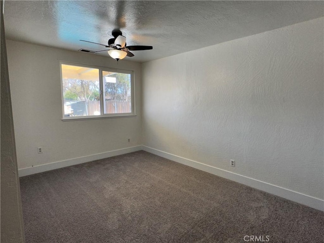 carpeted empty room featuring baseboards, a textured ceiling, and ceiling fan