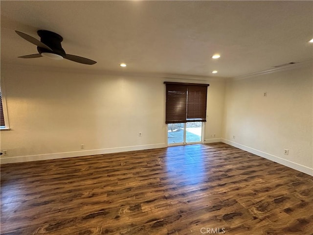 spare room featuring recessed lighting, baseboards, dark wood finished floors, and ornamental molding