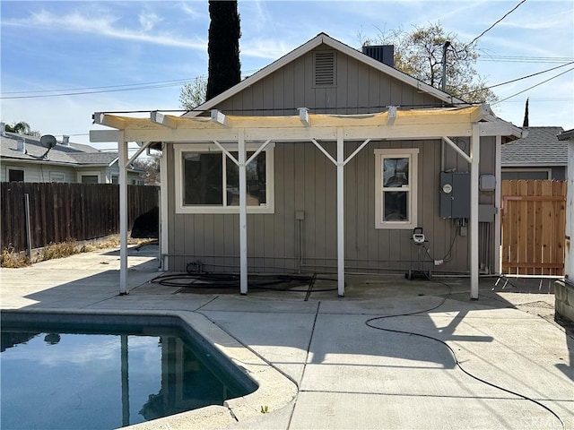 rear view of property with a patio, central air condition unit, a fenced in pool, and a fenced backyard